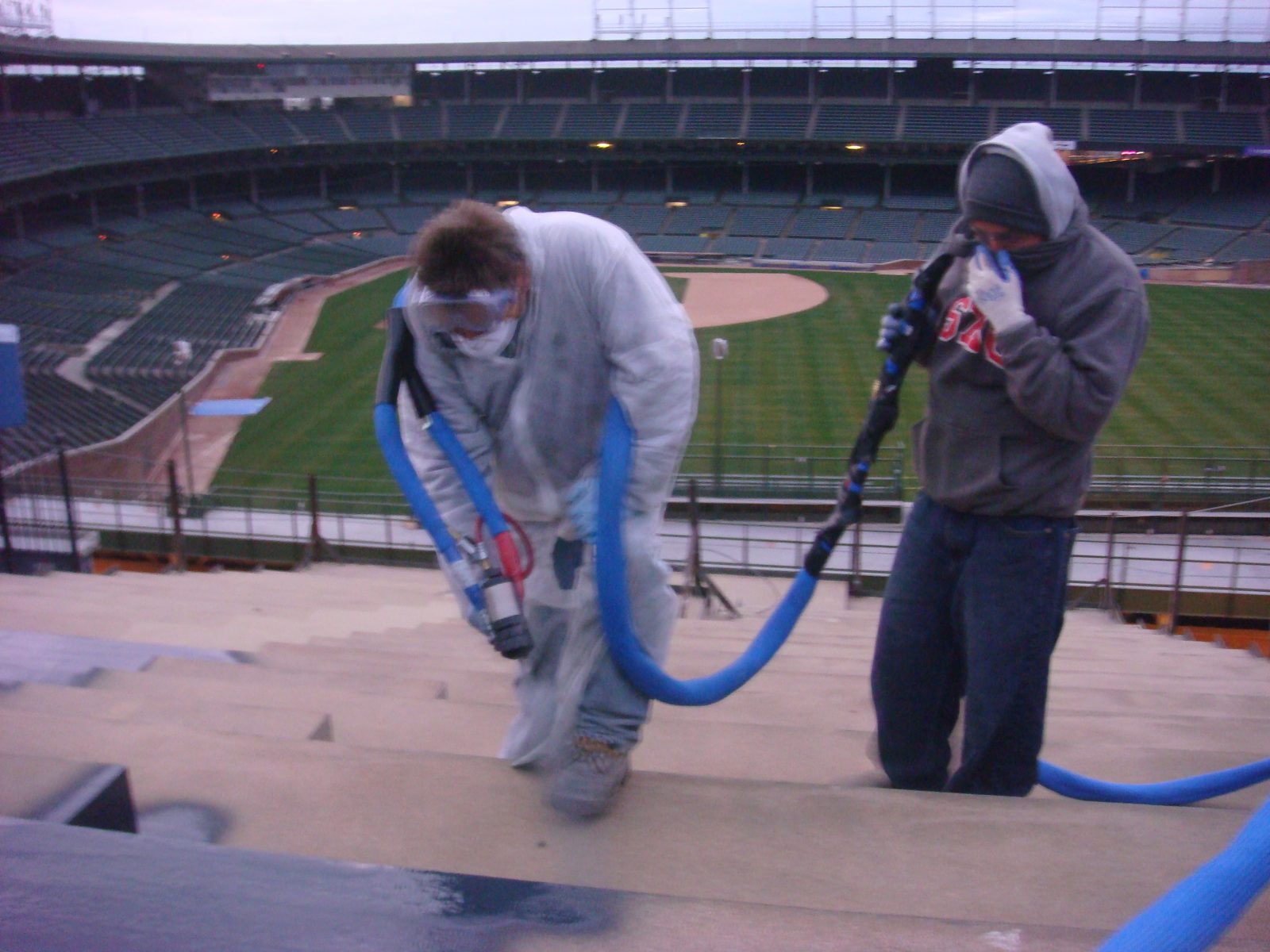 Concrete floor coated with a polyurea basecoat and topcoat system