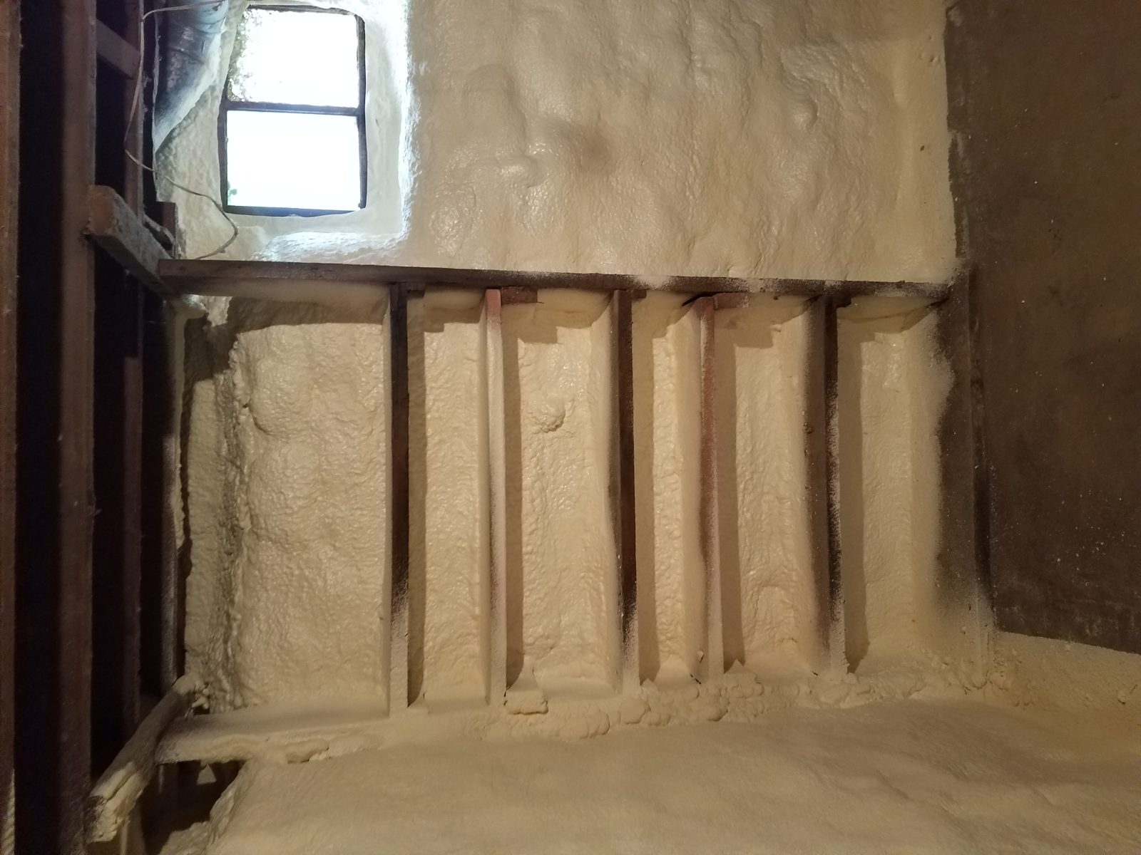 Closed-cell spray foam being applied