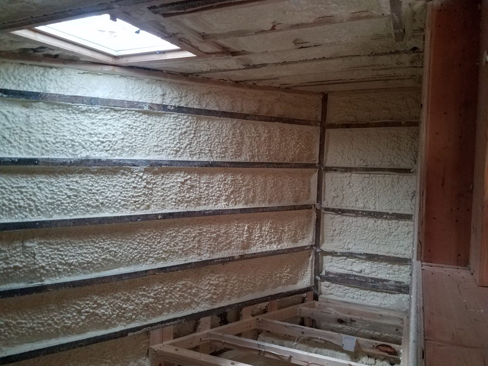 Spray polyurethane foam application on a building